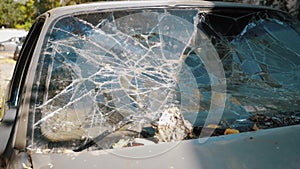 A breaking the glass of the car, vandalism.