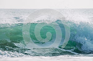 Breaking green wave close up