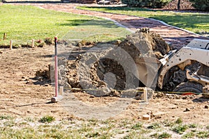 Breaking Ground Small Bulldozer Digging In Dirt and Grass