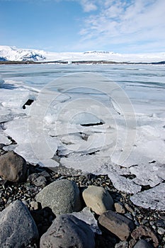 Breaking ice floe, gravel shore, Jokulsarlon, Iceland