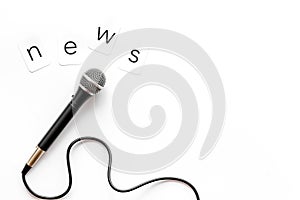 Breaking news concept. Microphone on white background top-down copy space