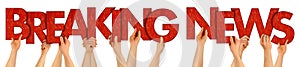 BREAKING NEWS people holding up red wooden letters photo