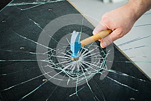 Breaking safety glass with a hammer