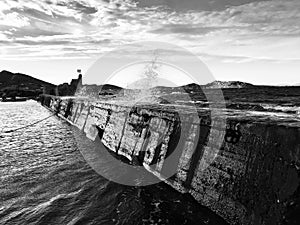 A breaking wall in the Naousa section of Paros, Greece with a crashing wave