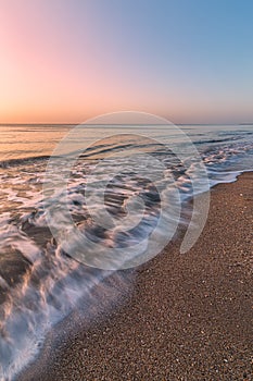 Breaking wave on the beach at sunrise, Florida, USA