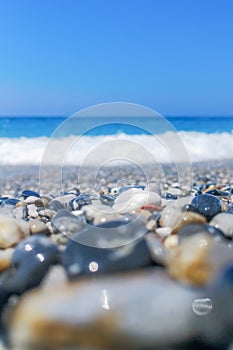 Breaking Wave of Blue Ocean on Pebbles beach Summer Background