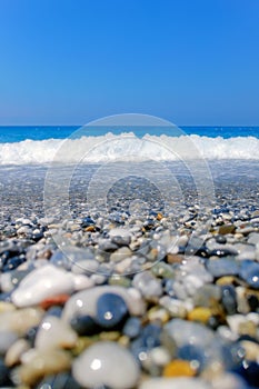 Breaking Wave of Blue Ocean on Pebbles beach Summer Background