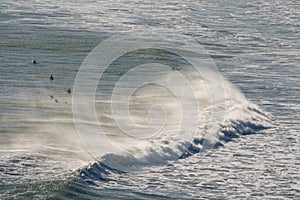 Breaking wave with surfers