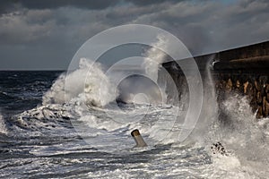 Breaking waves over Holyhead Breakwater