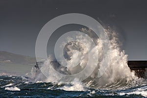 Breaking waves over Holyhead Breakwater