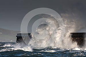 Breaking waves over Holyhead Breakwater