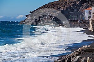 Breaking waves on pebble beach of Candelaria, Tenerife, Spain
