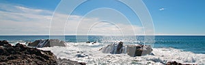 Breaking waves on rocky coastline at Cerritos Beach between Todos Santos and Cabo San Lucas in Baja California Mexico