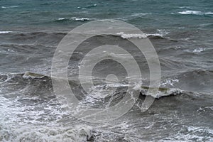 Breaking waves on a rough sea