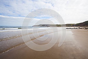 Breaking waves on sandy beach seascape