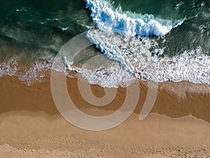 Breaking waves and sandy waters