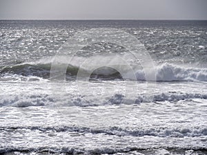 Breaking waves and seaspray, no land, Bad weather sea background. UK grey.