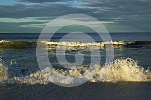 Breaking waves at sunrise gulf of mexico