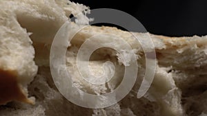 Breaking white bread. Super Macro. Narrow area of sharpness. Slow motion.