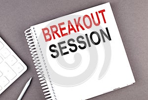 BREAKOUT SESSION text on notebook with calculator and pen,business concept