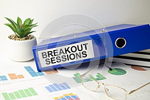 BREAKOUT SESSION text on notebook with charts and pen, business