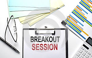 BREAKOUT SESSION text on the paper sheet with chart,color paper and calculator