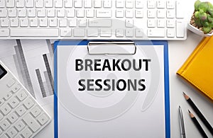 BREAKOUT SESSION written on the paper with keyboard, chart, calculator and notebook