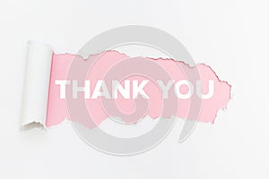 Breakthrough paper hole on isolated white background. Thank you