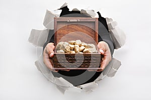 Breakthrough wall holding treasure chest photo
