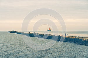 Breakwater with a lighthouse at the mouth of the river