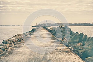 Breakwater with a lighthouse at the mouth of the river