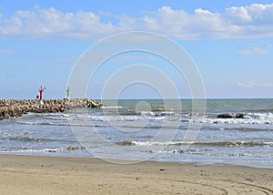 Breakwater with lighthouses on the beach on a summer day