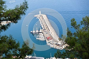 A breakwater with moored boats in the waters of the port of Alanya. Turkey