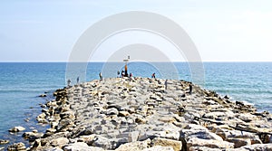 Breakwater with people