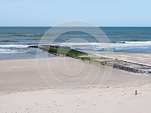 Breakwater on sandy beach of North Sea coast of West Frisian island Vlieland, Netherlands photo