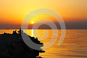 Breakwater in sunset with silouette of breakwater photo