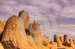 Breakwaters against the cloudy sky