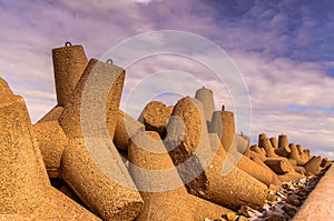 Breakwaters against the cloudy sky