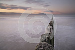 Breakwaters on the coast in Zeeuws-Vlaanderen, Zeeland, the Netherlands photo