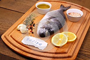 Bream fish on cutting board, recipe label