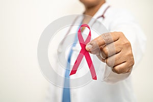 Breast cancer, Asian doctor woman with pink ribbon, symbol of World Breast Cancer Day