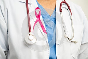 Breast cancer, Asian doctor woman with pink ribbon, symbol of World Breast Cancer Day