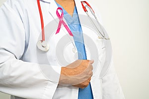 Breast cancer, Asian doctor woman with pink ribbon, symbol of World Breast Cancer Day