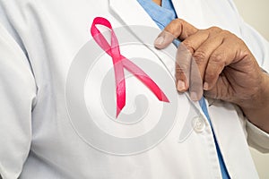 Breast cancer, Asian doctor woman with pink ribbon, symbol of World Breast Cancer Day