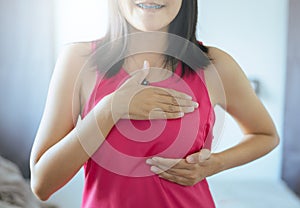 Breast cancer awareness concept,Happy asian woman hands holding on breast,Great for prevention cancer concept