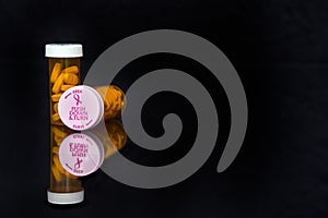 Breast cancer awareness lids on prescription vial photo