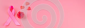 Breast Cancer Awareness Month. Pink ribbon and flower on colored background. Women's health care concept. Symbol of hope
