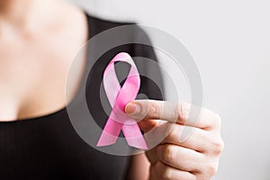 Breast Cancer Awareness and October Pink day. Woman holding Pink Ribbon. World cancer day