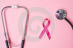 Breast Cancer Awareness, Pink Ribbon with Stethoscope on pink background for supporting people living and illness. Woman