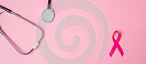 Breast Cancer Awareness, Pink Ribbon with Stethoscope on pink background for supporting people living and illness. Woman